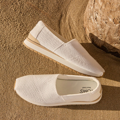 Laydown image of the women's white knit Resident Slip On sneakers