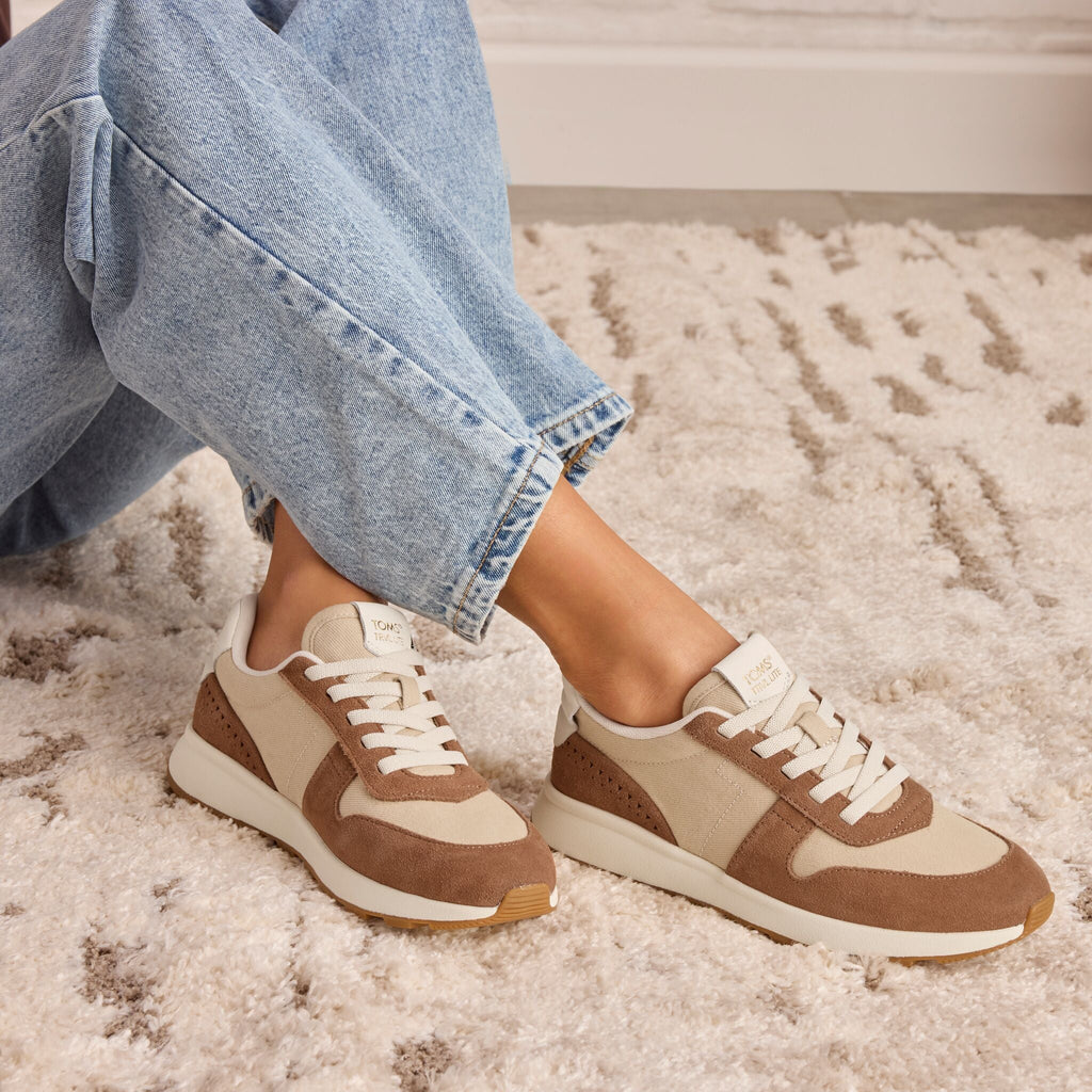 On model image of the TRVL LITE Retro Runner Sneaker in Water Repellent Brown Sugar