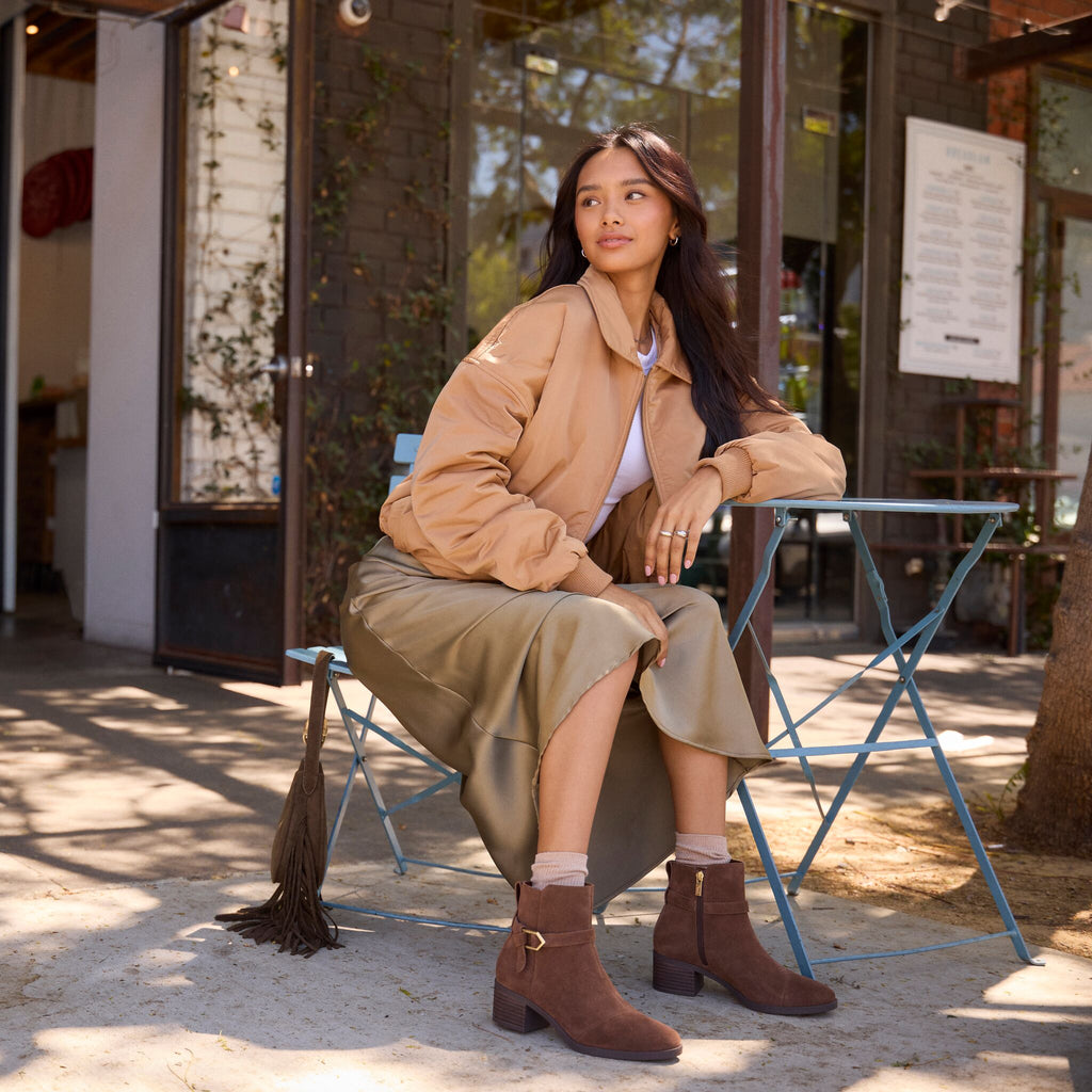 On model image of the Womens Delilah Buckle Ankle Boot Hot Cocoa Suede