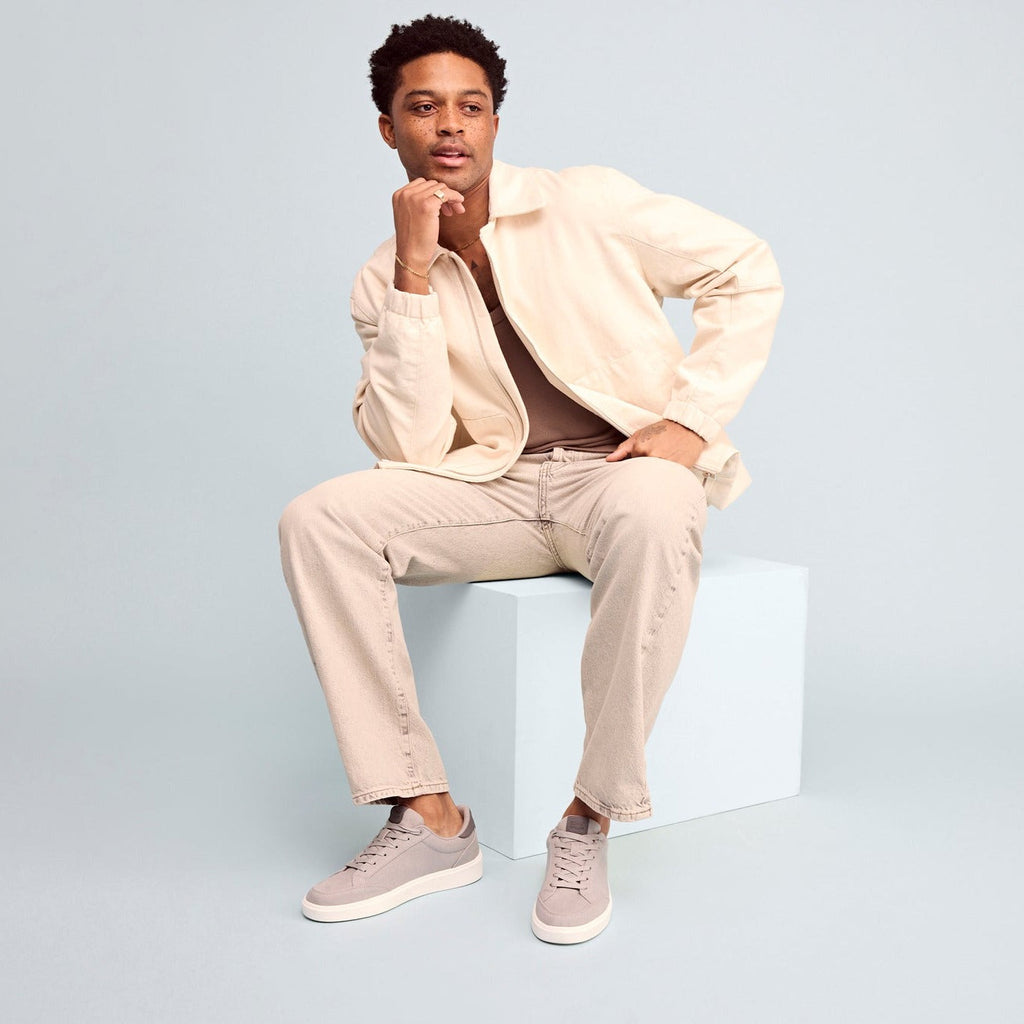 trvl lite rio lace up sneaker in grey textile on model in casual jeans and jacket