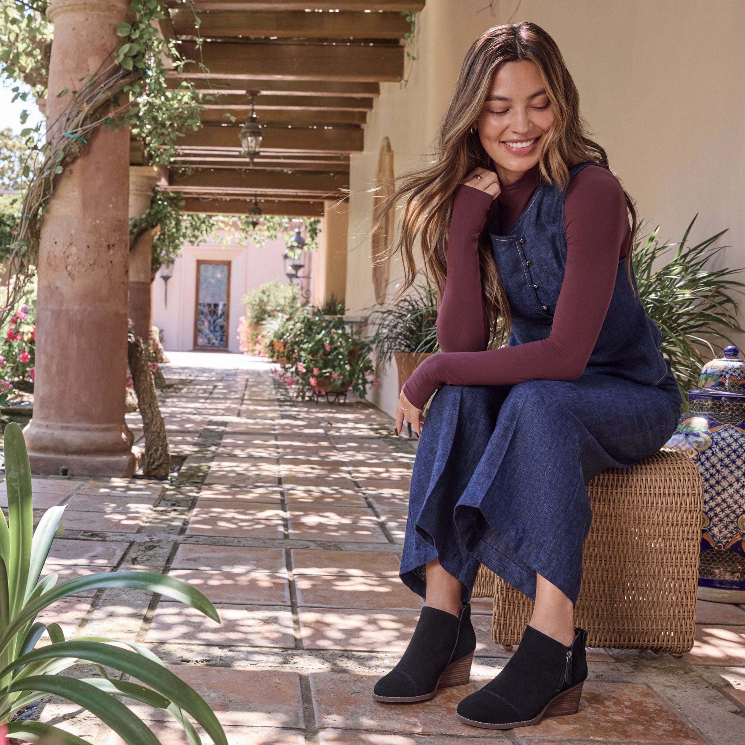 On figure image of the Black Suede Goldie wedge boot