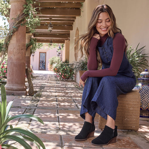 On figure image of the Black Suede Goldie wedge boot