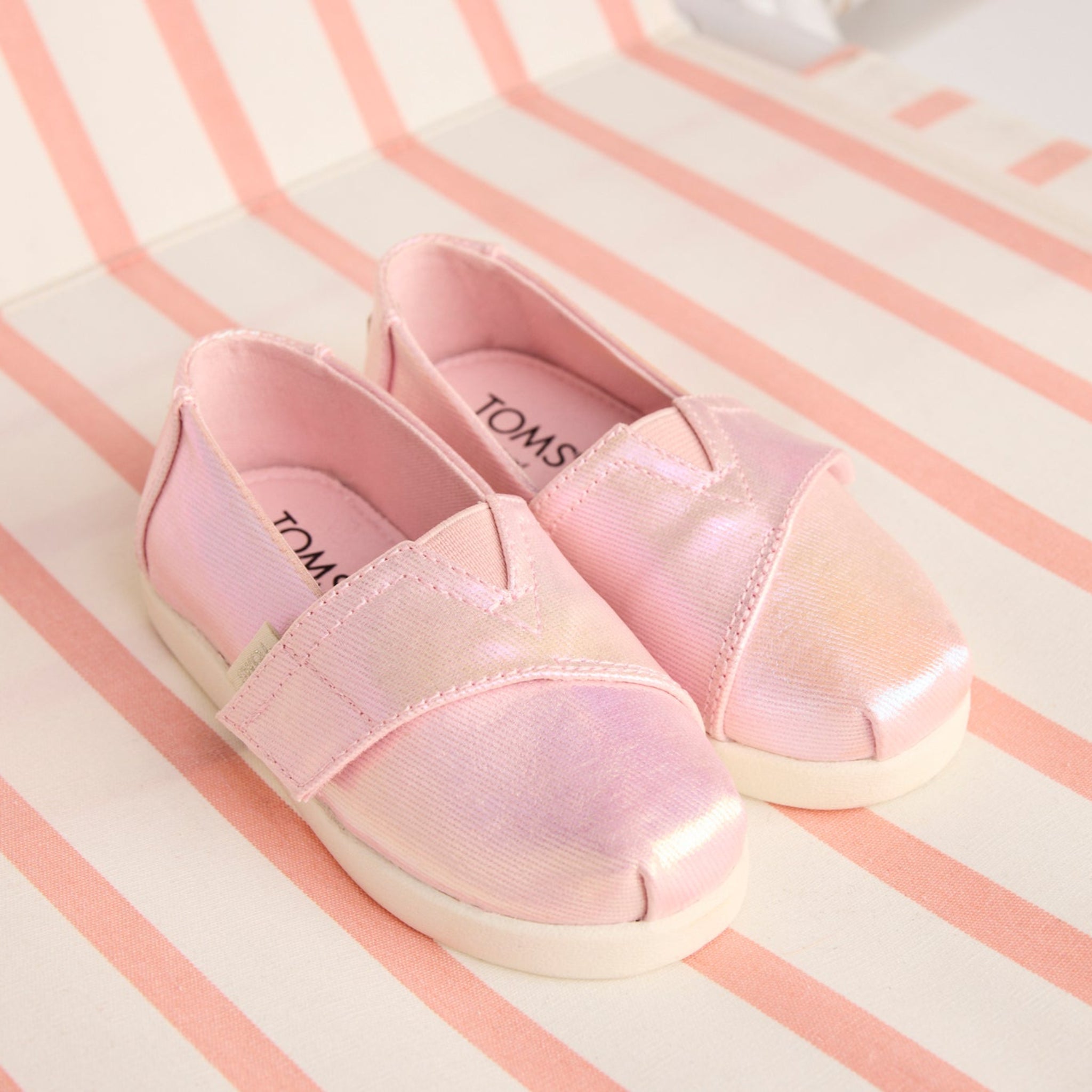 Laydown image of the Alpargata Classic TPR Pink Quartz Iridescent Twill Toddler Shoe