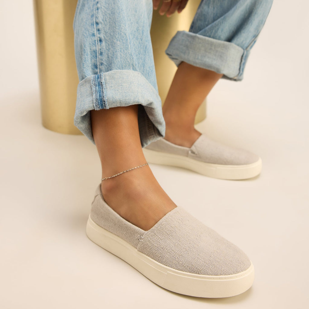Kameron slip on sneaker in grey on model sitting 