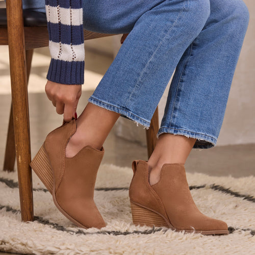 Model wearing the tan suede Gwen Wedge boot