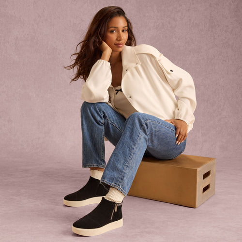 On model image of the Womens Percy Mid Platform Sneaker Water Resistant Black Suede