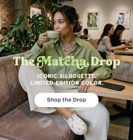The Matcha Drop. ICONIC SILHOUETTE. LIMITED EDITION COLOR. Shop the Drop: model in cafe sipping from a mug while wearing the Alpargata Classic in Matcha Cafe Print.
