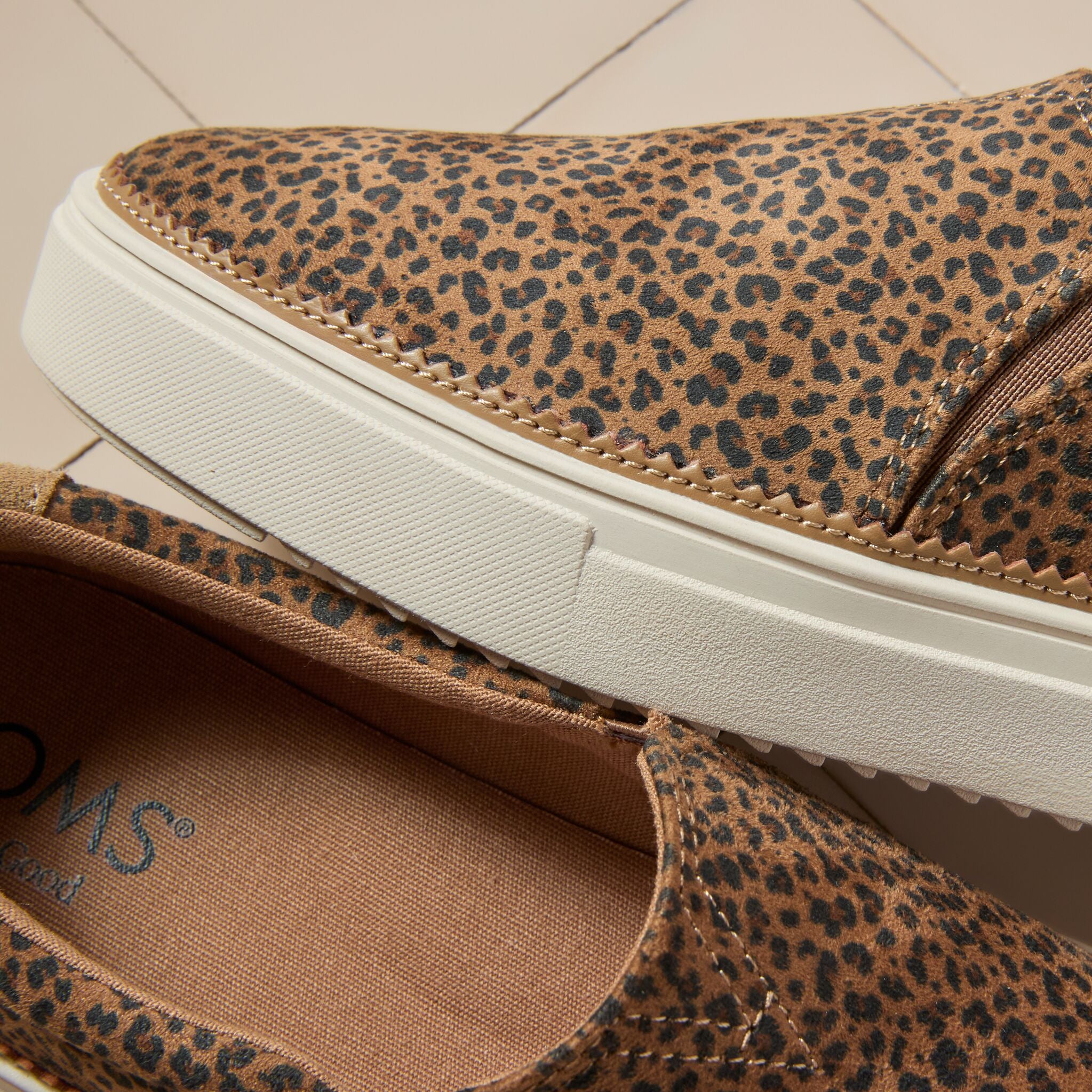 Laydown detail image of the toffee leopard print Emily slip on sneaker